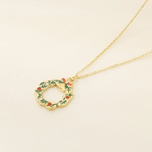 Festive gold Christmas wreath pendant necklace with green enamel and sparkling crystals