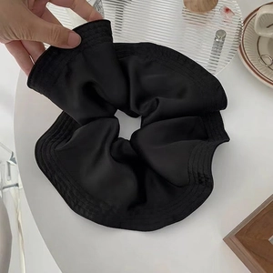 Elegant large black satin scrunchie with soft pleated texture and high elasticity
