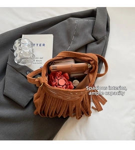 Brown suede bucket bag detail showing large interior capacity for phone and umbrella