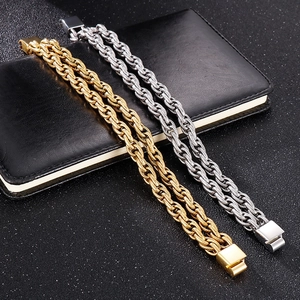 Bracelets gourmette de moto en acier inoxydable doré et argenté sur carnet en cuir