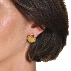 Close-up of a gold irregular brushed stainless steel stud earring worn on the ear