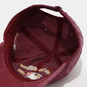 Detail of burgundy baseball cap interior with 250th anniversary embroidery and metal buckle