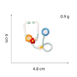 Detail of stethoscope embroidery patch with floral accents measuring 6 cm by 4.8 cm