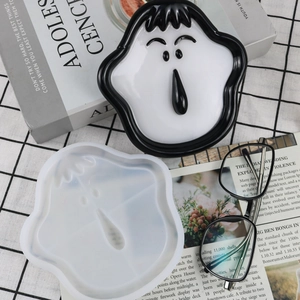 Detailed view of cartoon nose and glasses silicone mold with finished resin storage tray