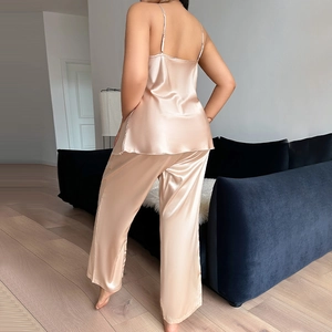 Women's champagne gold satin pajama set featuring camisole top and long trousers