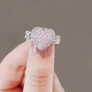 Pink pave heart ring with silver chain band design shown on finger for size reference