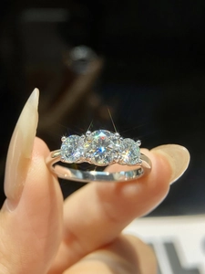 Macro shot of 925 silver ring featuring three brilliant-cut round moissanite stones