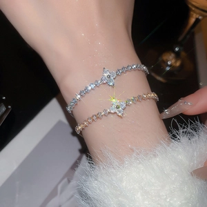 Close-up of elegant clover bracelets with inlaid zircons and silver finish detail
