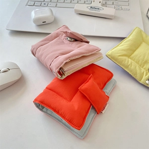Detailed close-up of quilted fabric binder journals in pink orange and yellow colors