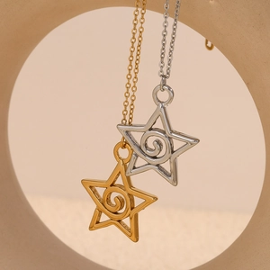 Detailed close-up of gold and silver hollow star pendants with spiral design