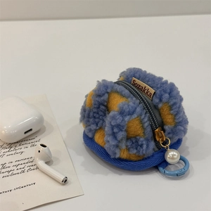 Detail of blue and yellow checkerboard plush case for AirPods with pearl keychain