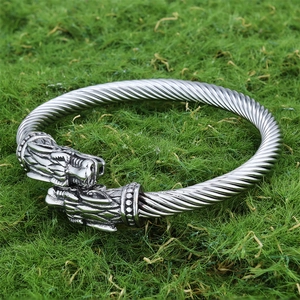 Vintage viking wolf head open bangle with twisted rope texture on green background