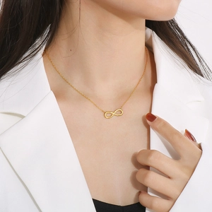 Elegant 18k gold plated titanium steel infinity heart necklace on female model