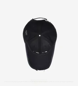 Detail view of the black cotton baseball cap interior featuring XTMY brand label and seams