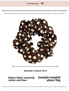 Detail view of 15cm brown polka dot cotton linen hair scrunchie with soft natural texture