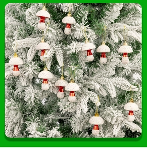 Detail of red and white mushroom Christmas ornaments hanging on a snowy tree branch
