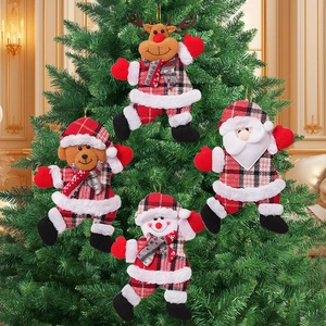 Close-up of four red plaid Christmas ornaments hanging on a festive green pine tree