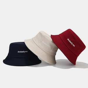 Three embroidered bucket hats in navy, beige, and burgundy colors with a minimalist style