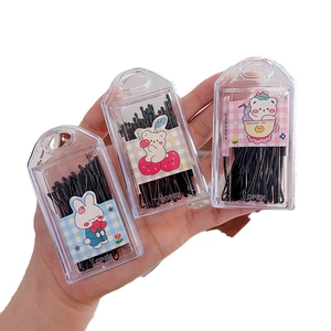 Set of black wavy metal bobby pins in a clear plastic organizer box for hair styling