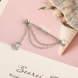 Detail of stainless steel industrial barbell with crescent moon charm and zircon chain