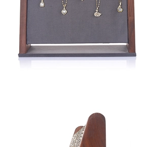 Detail view of walnut wood necklace display stand with gray velvet and gold hooks
