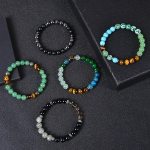 Natural tiger eye and turquoise beaded wealth bracelets for men and women on dark texture