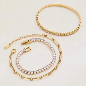 Detailed view of three-piece gold stainless steel jewelry set with sparkling zircon stones