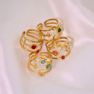 Gold stainless steel moon star rings with colorful stones on white silk background