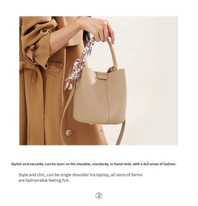 Close-up of beige lychee leather bucket bag with printed silk scarf on the top handle