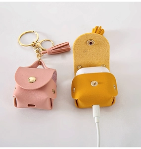 Detail of PU leather case for AirPods featuring metal snap closure and charging port cutout