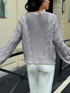 Detail view showing the grey cable knit texture on the back of this women's sweater