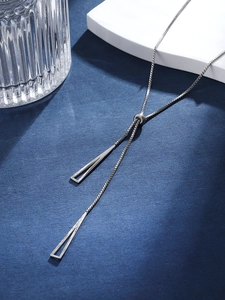 Close-up of a silver Y-necklace with geometric hollow bar pendants and adjustable slider chain