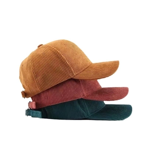 Corduroy baseball caps in mustard yellow, burgundy and dark green with metal buckles