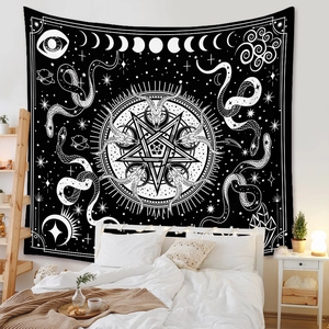 Close-up of black and white bohemian tapestry featuring moon phases and mystical motifs