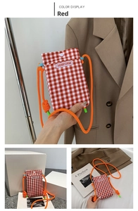Detail of red checkered crossbody phone bag with orange rope strap and logo patch