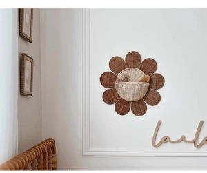 Detail of woven sunflower wall basket made of natural rattan for storage and nursery decor