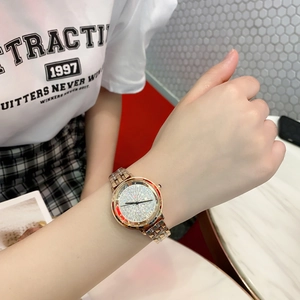 Elegant rose gold women's watch with crystal-encrusted dial shown on a wrist