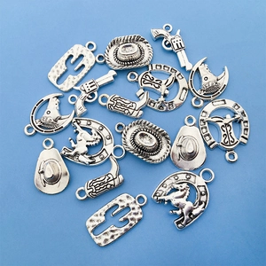 Selection of silver cowboy charms including boots and hats on a light blue background