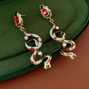 Detail of vintage snake earrings with colorful enamel and sparkling crystal accents