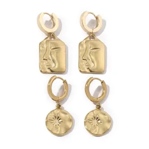 Golden stainless steel earring set featuring face relief and starburst patterns
