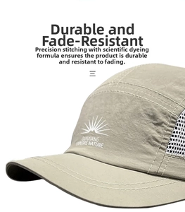 Detail of five-panel khaki camper hat with white mesh side and mountain embroidery