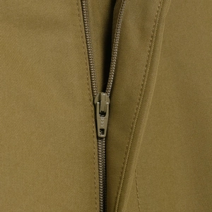 Macro shot of metal zipper and khaki twill fabric texture on cargo shorts suit