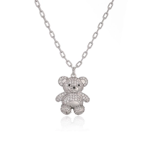 Macro shot of silver teddy bear pendant with zircons and fashionable paperclip chain