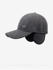 Detail of dark grey winter baseball cap with ear flaps and thick fleece lining texture