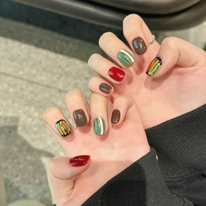 Handmade press-on nails in retro fall colors featuring artistic abstract hand-painted patterns
