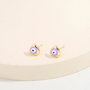 Triangle evil eye stud earrings with gold plating and enamel inlay on a cream stand