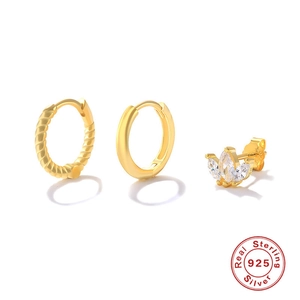 Close-up of three-piece 925 sterling silver set featuring gold hoop and zircon stud