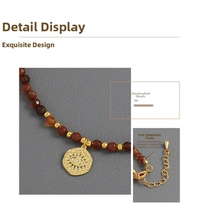 Detail of 18k gold plated evil eye pendant with 5cm extension chain and red beads