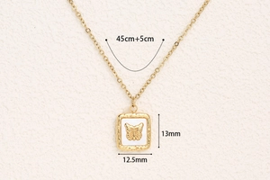 Detail of square gold butterfly necklace showing size dimensions 13mm by 12.5mm