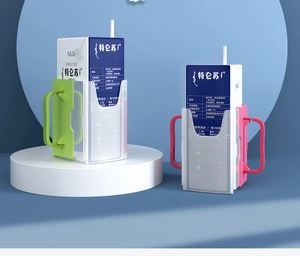 Macro detail of red and green plastic anti-squeeze milk carton holders with side handles